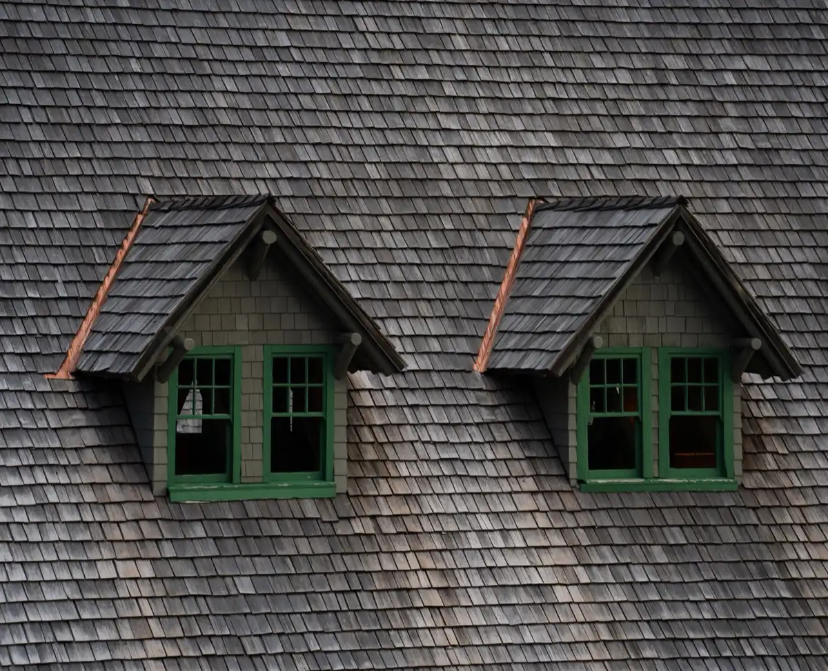 Dormers on a shingle roof in Little Rock, AR, where step flashing and kickout flashing carry water past the walls